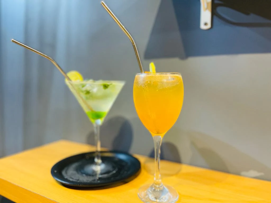 Two drinks served on the patio table