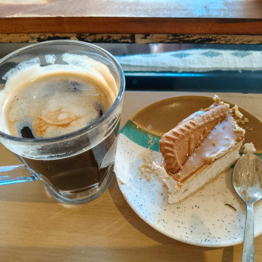 Iced coffee and a sandwich by the window