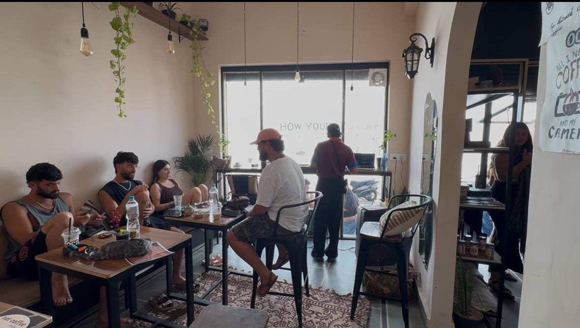 Guests seated and chatting inside the cafe, cozy morning ambience