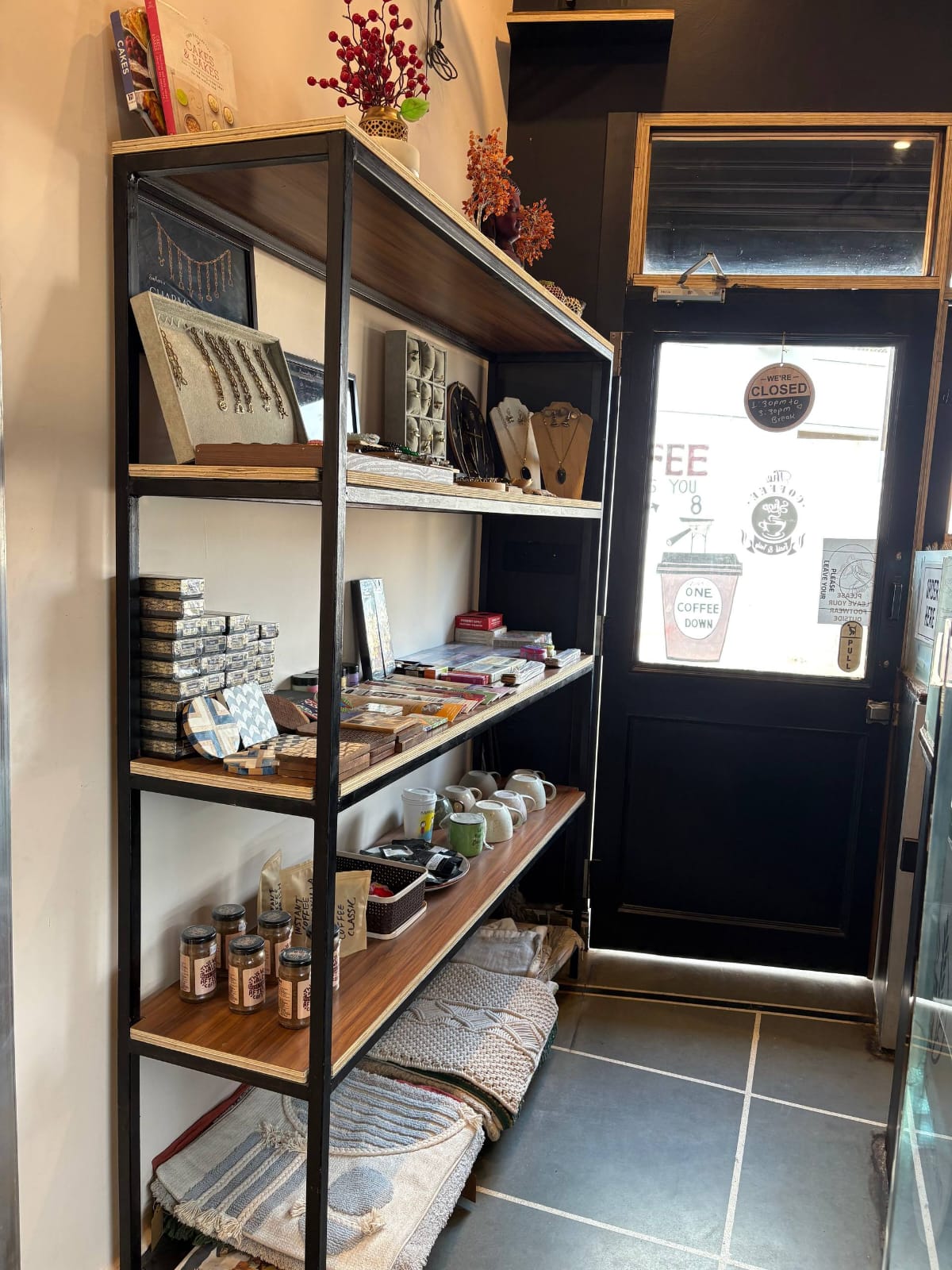 Shelf of coffee bags and stationery near the entrance