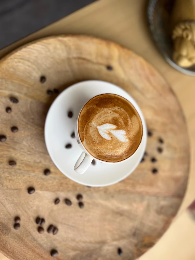 Latte art in a ceramic cup on a wooden table