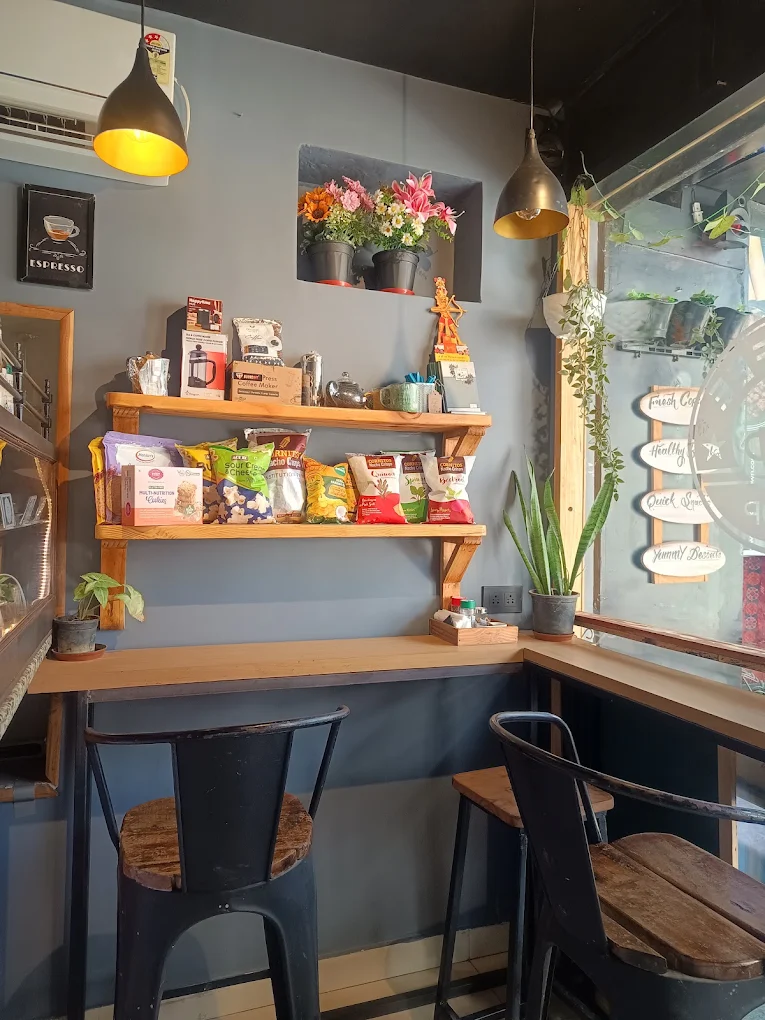 Cozy shelf-side seating nook inside One Coffee Down
